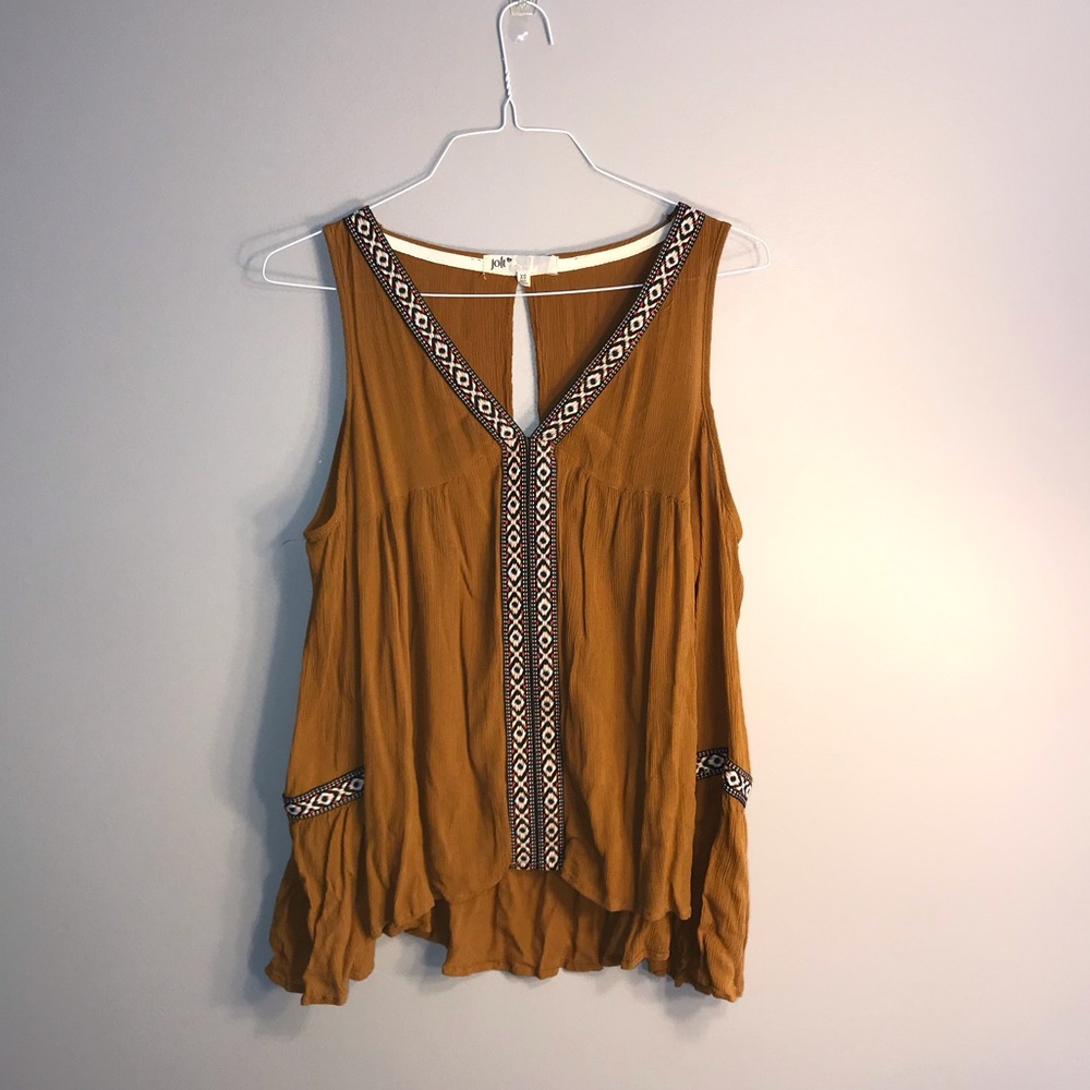 Tan top with shoulder cutouts and colorful accents